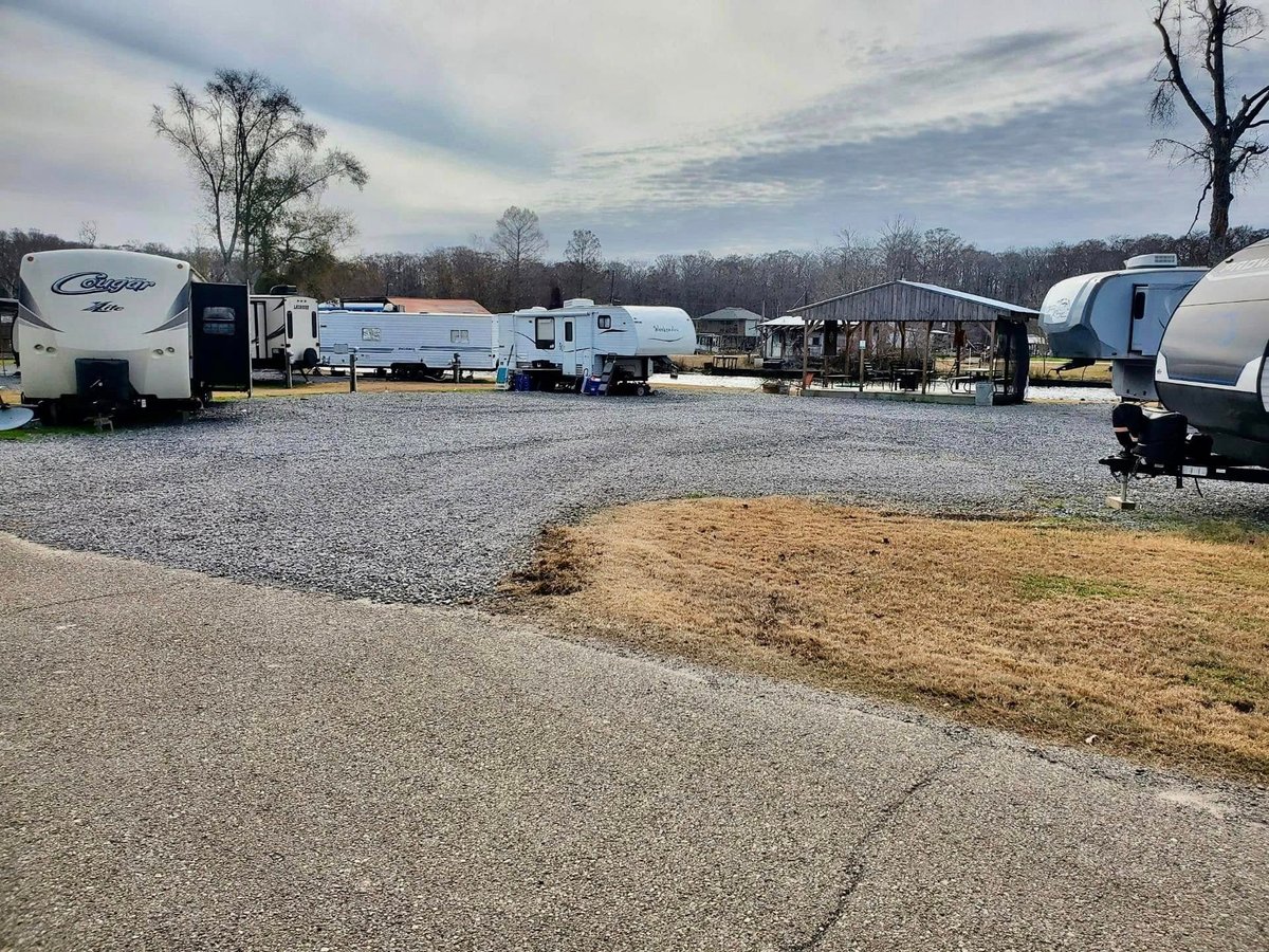 RV camping lot with multiple trailers at Old River RV Park